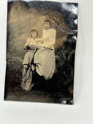 Item #86964 GROUP OF THREE TINTYPE PHOTOGRAPHS OF WOMEN POSING ON OR BESIDE THEIR BICYCLES ...